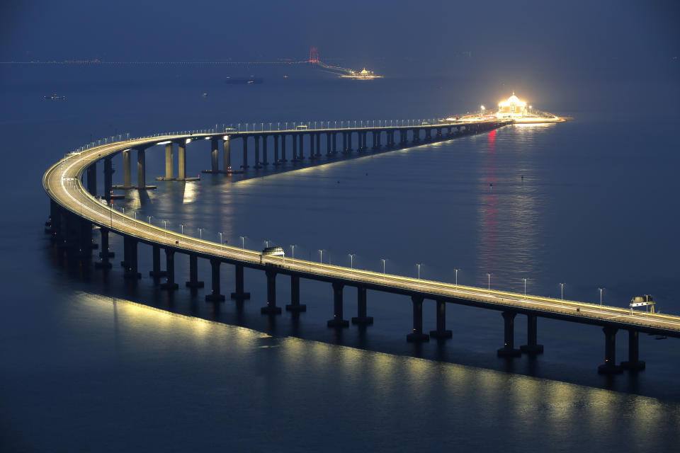 The Hong Kong-Zhuhai-Macau Bridge is lit up in Hong Kong, Monday, Oct. 22, 2018. The bridge, the world's longest cross-sea project, which has a total length of 55 kilometers (34 miles), will have opening ceremony in Zhuhai on Oct. 23. (AP Photo/Kin Cheung)