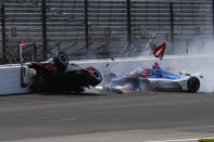 Katherine Legge, of England, left, and Stefan Wilson, of England, crash in the first turn during practice for the Indianapolis 500 auto race at Indianapolis Motor Speedway in Indianapolis, Tuesday, May 23, 2023. (AP Photo/Kirk DeBrunner)