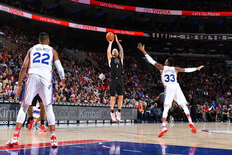 J.J. Redick shows Robert Covington and Richaun Holmes how he can help. (Getty Images)