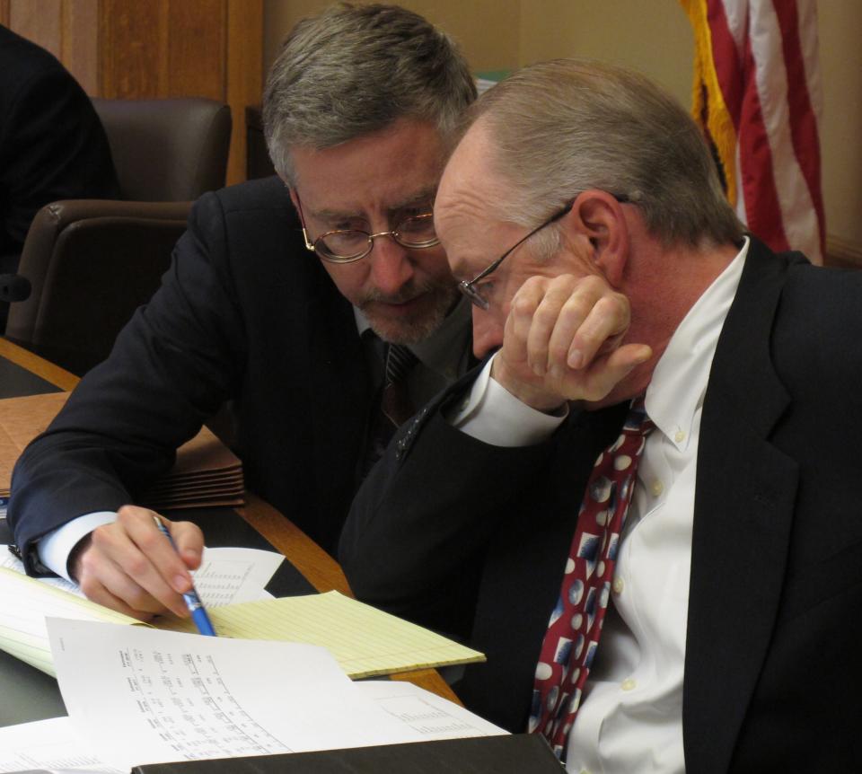 Chris Courtwright, left, principal analyst for the Kansas Legislative Research Department, and Gordon Self, right, an attorney on the Legislature's bill-drafting staff, confer as lawmakers negotiate over tax cuts, Monday, April 30, 2012, at the Statehouse in Topeka, Kan. Courtwright is the research staff's tax policy expert, and Self drafts legislation dealing with taxes. (AP Photo/John Hanna)