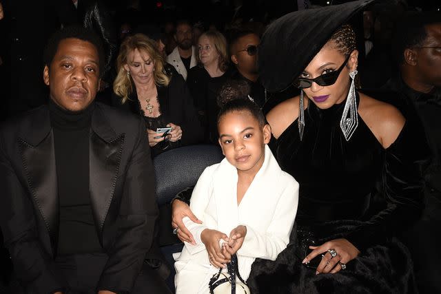 <p>Michele Crowe/CBS via Getty Images</p> Jay-Z, Blue Ivy and Beyoncé at the 60th Annual Grammy Awards.