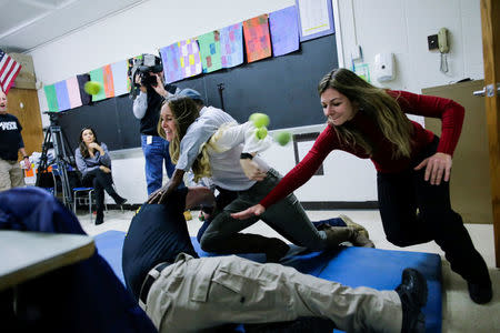 School teachers and staff members take part during an active shooter training at James I. O'Neill High School in Highland Falls, New York, U.S., December 12, 2017. REUTERS/Eduardo Munoz