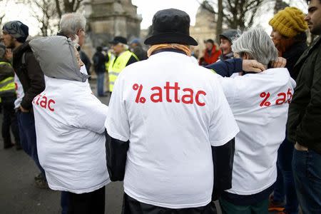 Activists from the anti-globalisation organisation Attac attend a demonstration to protest against the banking system and tax fraud, at the start of the trial of former French budget minister Jerome Cahuzac near the courts in Paris, France, February 8, 2016. REUTERS/Charles Platiau