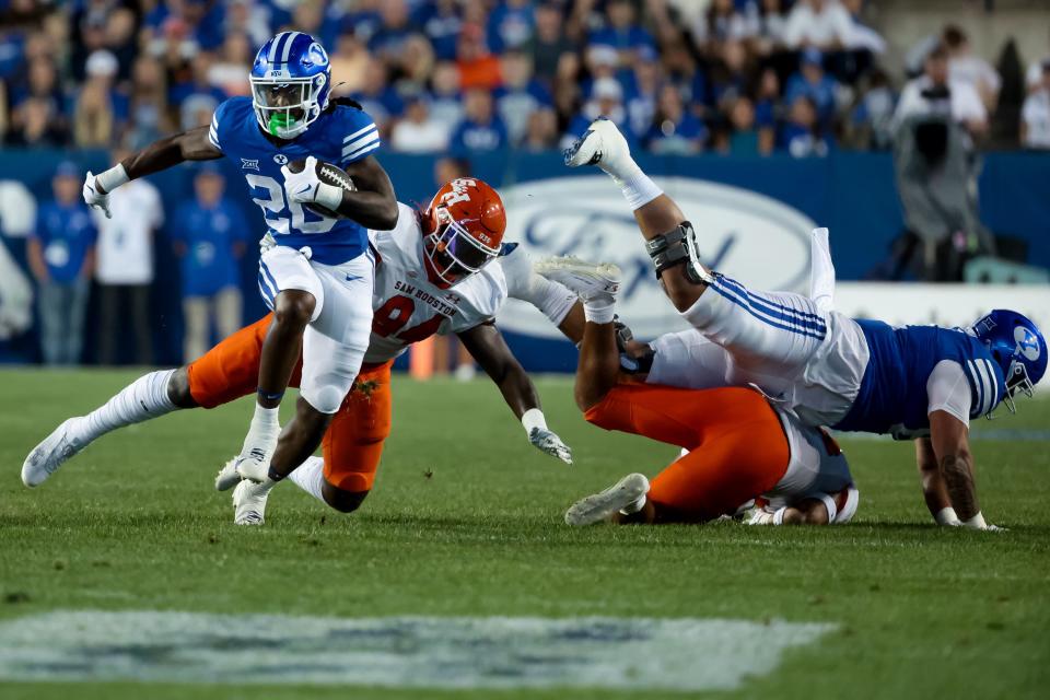 BYU Cougars running back Deion Smith (20) runs the ball during the game against the Sam Houston Bearkats at LaVell Edwards Stadium in Provo on Saturday, Sept. 2, 2023. | Spenser Heaps, Deseret News