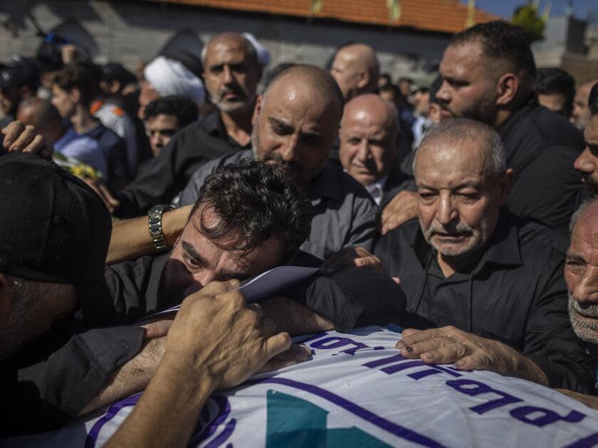 Mohammed Shou at the burial of his three daughters in Blida, in southern Lebanon. The girls and their grandmother were killed by an Israeli airstrike Sunday.