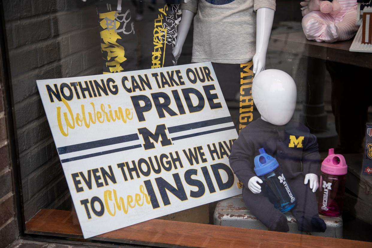 M Den near U-M central campus in Ann Arbor has a sign on display outside "Nothing can take our Wolverine pride, even though we have to cheer inside", Friday, Oct. 30, 2020.