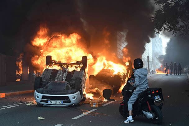 PHOTO: Cars burn in the street in the Paris suburb of Nanterrie, France, on June 29, 2023, following a commemoration march for 17-year-old Nahel M. who was shot dead by a police officer two days earlier. (Bertrand Guay/AFP via Getty Images)
