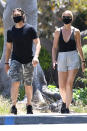 <p>Gwyneth Paltrow and Brad Falchuk enjoy a stroll together in Los Angeles as they dress in color-coordinated masks and tops on Saturday.</p>