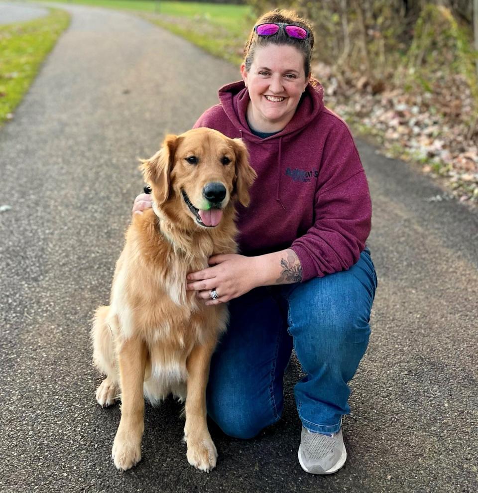 Ashton Metheny and one of her dogs. Metheny runs a training school for dogs to learn basic skills and more.