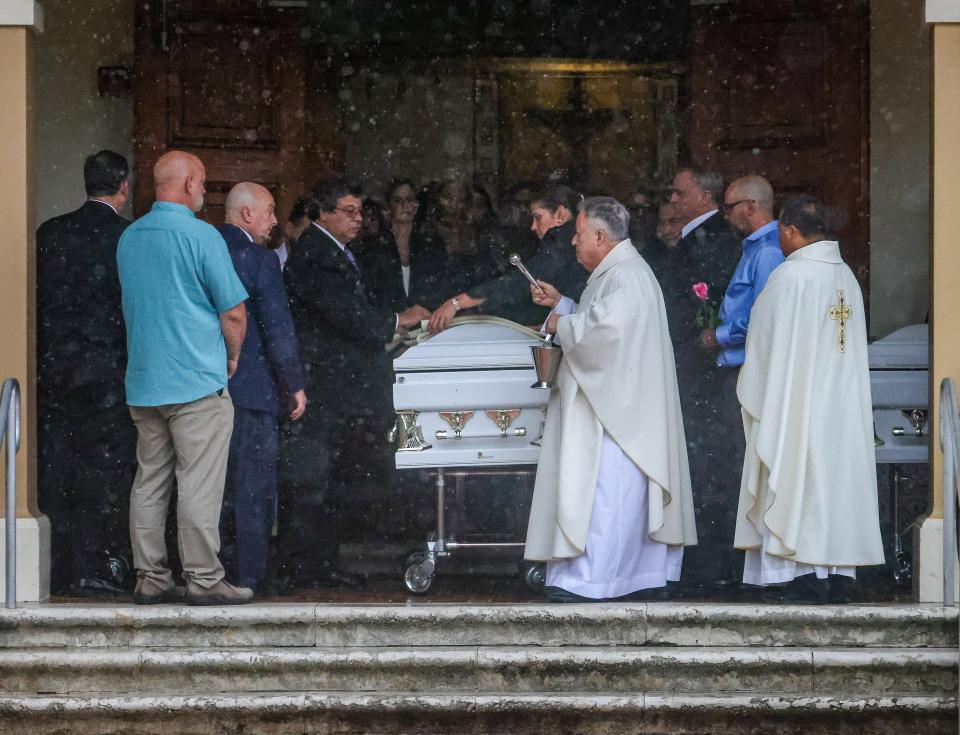 Father Juan Sosa, the pastor of St. Joseph Catholic Church, pronounces a blessing following the funeral Mass for the Guara family. Marc Guara, his wife Anaely Rodriguez, and their daughters Lucia and Emma died in the Champlain Towers South condo collapse.