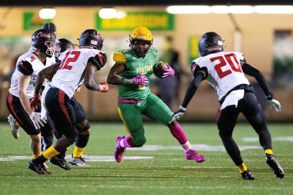 Bryan Station running back Kalen Washington (1) runs the ball against George Rogers Clark at Bryan Station High School on Friday. Washington scored three touchdowns.