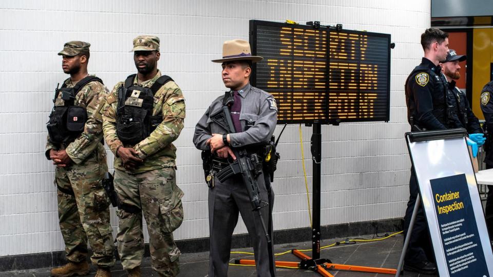 PHOTO: New York State Police officer, members of the New York State National Guard and NYPD officers stand guard in a check point to check bags inside the entrance of subway station in New York, on March 7, 2024. (Eduardo Munoz/Reuters, FILE)