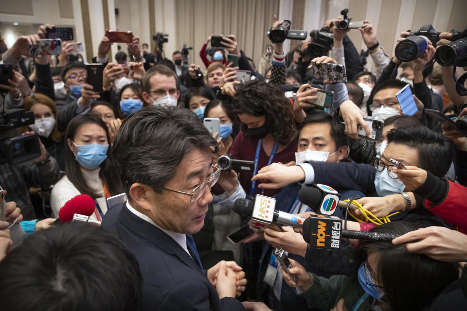 FILE - In this Sunday, Jan. 26, 2020 file photo, Gao Fu, foreground left, the head of the Chinese Center for Disease Control and Prevention, speaks to journalists after a news conference about a virus outbreak at the State Council Information Office in Beijing. On Dec. 31, 2019, Gao dispatched a team of experts to Wuhan. Also on Dec. 31, the World Health Organization first learned about the cases from an open-source platform that scouts for intelligence on outbreaks, emergencies chief Michael Ryan has said. (AP Photo/Mark Schiefelbein)