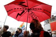 A woman holds an umbrella as she takes part in a protest against the ruling by Poland's Constitutional Tribunal that imposes a near-total ban on abortion in Warsaw
