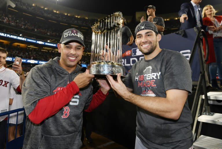 Winners: Red Sox manager Alex Cora and World Series MVP Steve Pearce hoist the World Series trophy after beating the Dodgers in five games