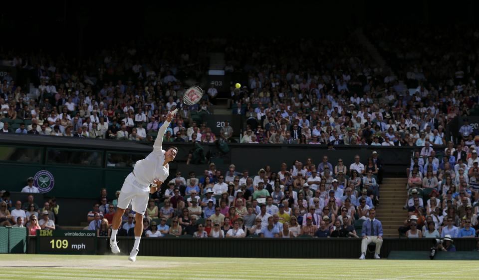 Milos Raonic of Canada serves during his men's singles semi-final tennis match against Roger Federer of Switzerland at the Wimbledon Tennis Championships, in London July 4, 2014. REUTERS/Stefan Wermuth (BRITAIN - Tags: SPORT TENNIS)