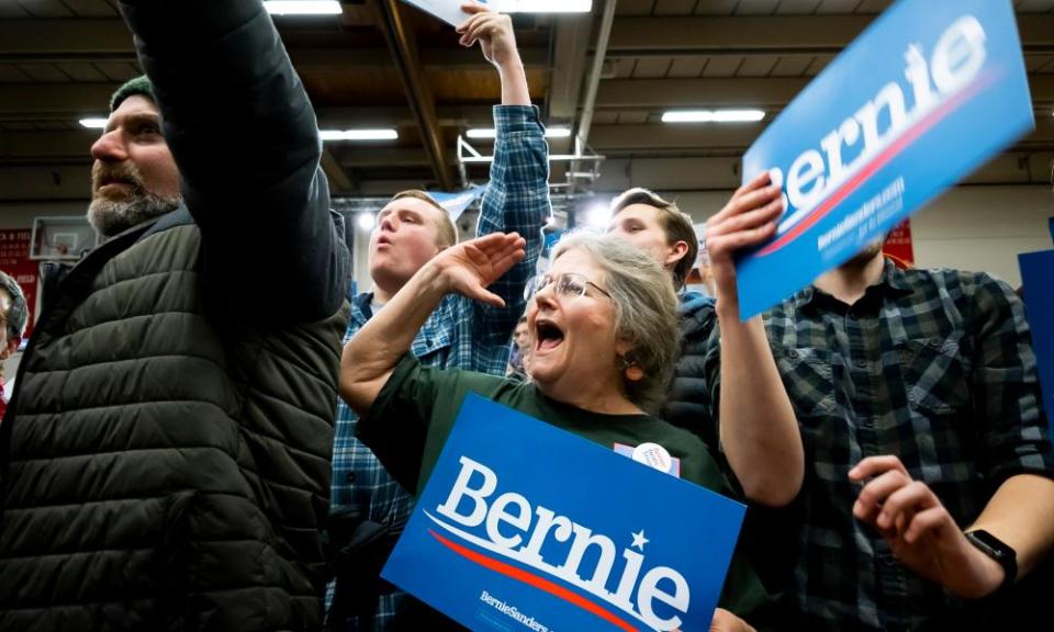 Supporters holding up Bernie Sanders signs