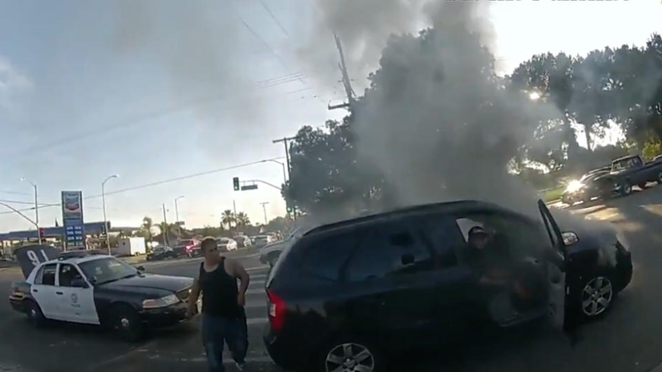 LAPD police help rescue a wheelchair user from a burning car. 