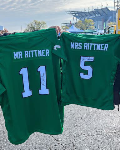 <p>Philadelphia Eagles/Instagram</p> Brooke and Rob Rittner received matching jerseys from the Eagles, autographed by Jason Kelce.