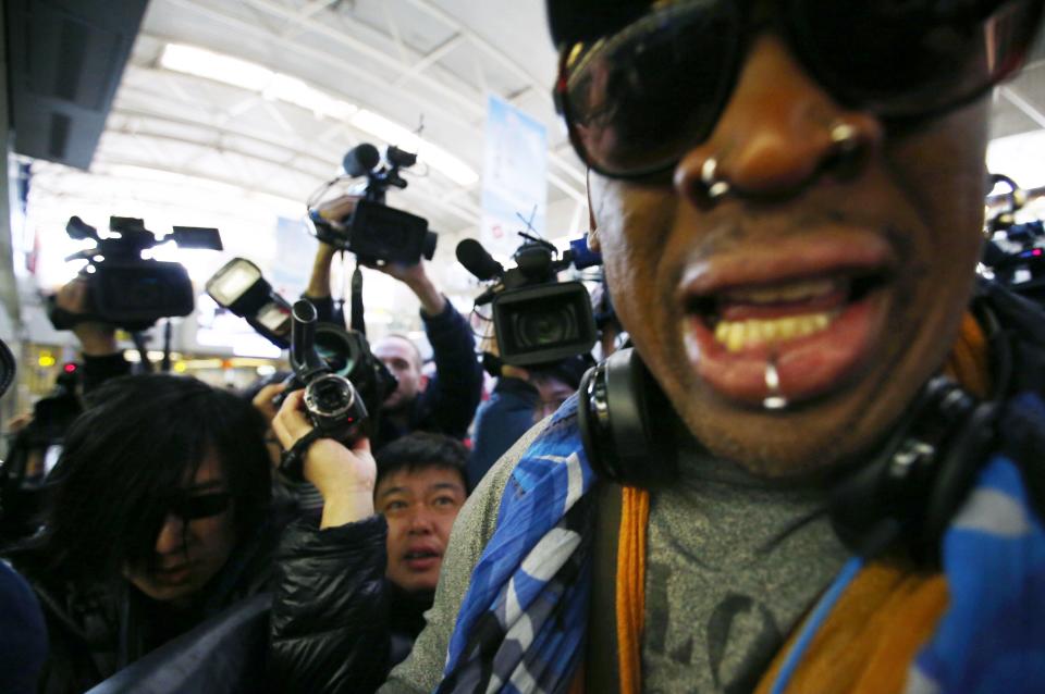 Former NBA basketball player Dennis Rodman (R) is surrounded by the media at Beijing International Airport December 19, 2013 before he leaves for Pyongyang. Rodman said on Thursday he was not going to North Korea to talk about politics or human rights, despite political tension surrounding the execution of leader Kim Jong Un's uncle. (REUTERS/Petar Kujundzic)