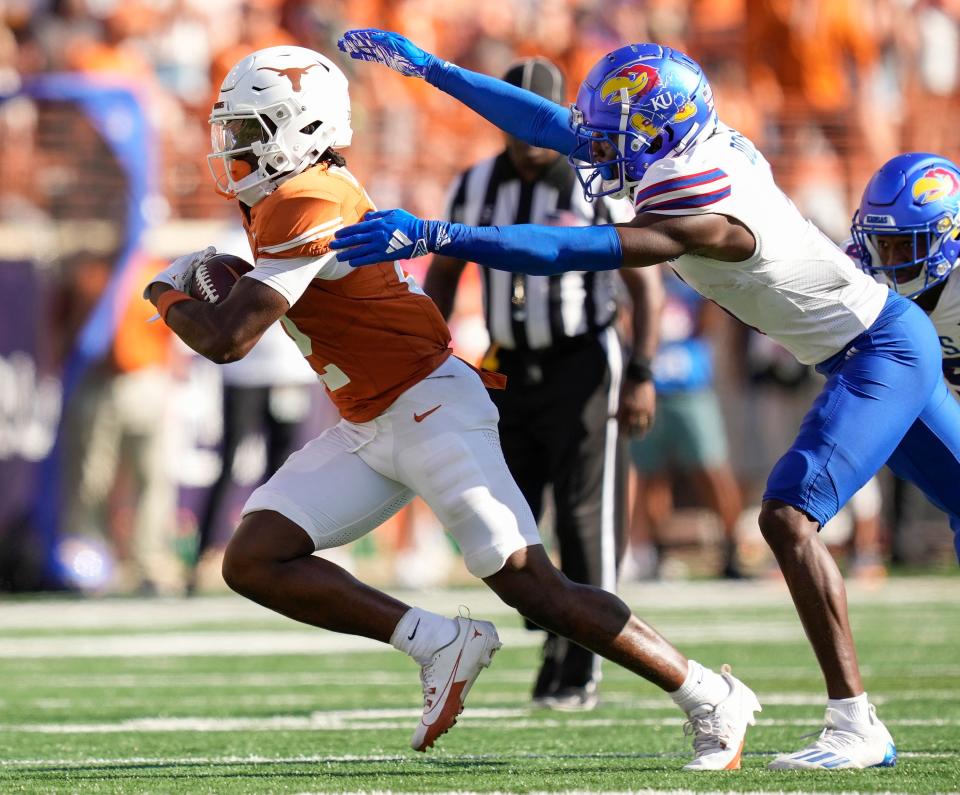Texas Longhorns wide receiver Johntay Cook II makes a reception against <a class="link " href="https://sports.yahoo.com/ncaaf/teams/kansas/" data-i13n="sec:content-canvas;subsec:anchor_text;elm:context_link" data-ylk="slk:Kansas Jayhawks;sec:content-canvas;subsec:anchor_text;elm:context_link;itc:0">Kansas Jayhawks</a> cornerback Mello Dotson in the third quarter at Royal-Memorial Stadium on Saturday September 30, 2023.