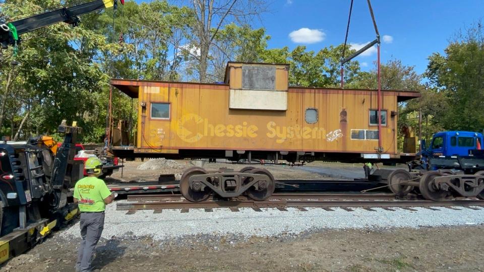 A rustic yellow Chessie System caboose