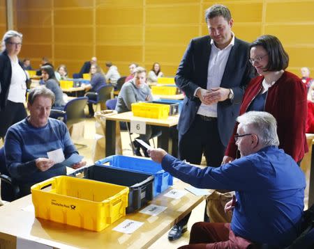 Andrea Nahles (R) and Lars Klingbeil of Social Democratic Party (SPD) look on as party members count ballot papers of the voting for a possible coalition between the Social Democratic Party (SPD) and the Christian Democratic Union (CDU) in the SPD headquarters in Berlin, Germany March 3, 2018. REUTERS/Hannibal Hanschke