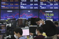 Currency traders work at the foreign exchange dealing room of the KEB Hana Bank headquarters in Seoul, South Korea, Friday, Oct. 23, 2020. Shares were mostly higher in Asia on Friday after President Donald Trump and his challenger former Vice President Joe Biden faced off in their second and final debate before the Nov. 3 election. (AP Photo/Ahn Young-joon)