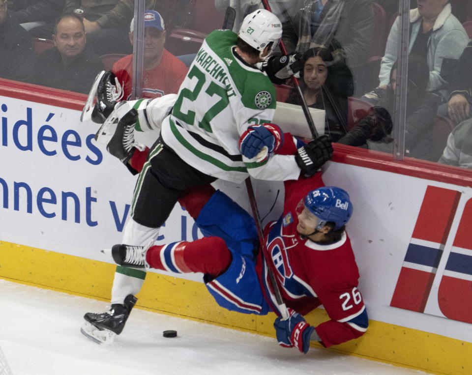 Dallas Stars' Mason Marchment (27) hits Montreal Canadiens' Johnathan Kovacevic (26) during first-period NHL hockey game action Saturday, Oct. 22, 2022, in Montreal. (Ryan Remiorz/The Canadian Press via AP)