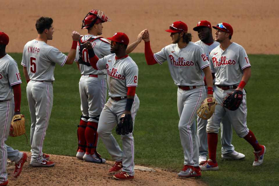 Philadelphia Phillies shortstop Jean Segura (2) celebrates with teammates after defeating the New York Mets in a baseball game on Monday, Sept. 7, 2020, in New York. (AP Photo/Adam Hunger)