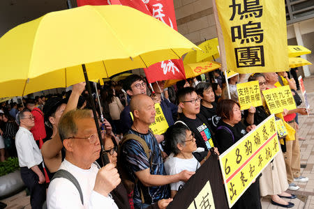 Pro-democracy supporters hold yellow umbrella to support leaders of Occupy Central activists, outside the court, in Hong Kong, China April 9, 2019. REUTERS/Tyrone Siu