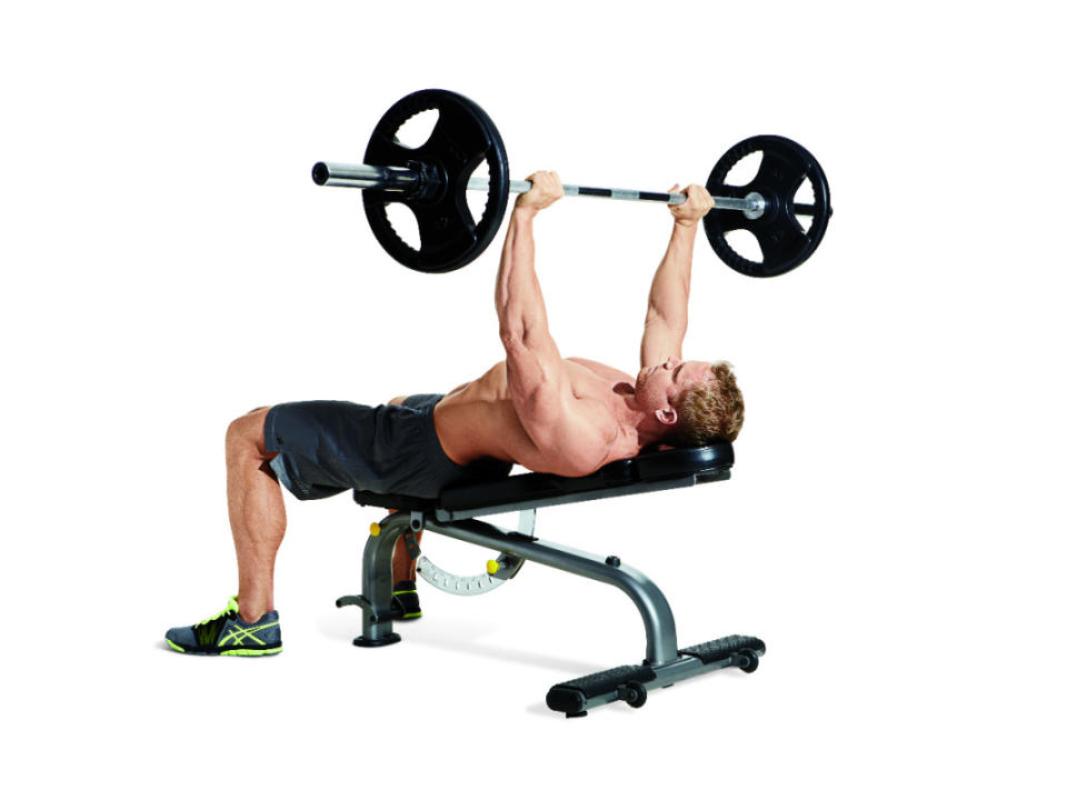 How to do it:<ol><li>Set an adjustable bench to an incline of no more than 30°, or rest a flat bench on a weight plate or mat to tilt it slightly.</li><li>Grasp the bar just outside shoulder-width, and arch your back so there’s space between your lower back and the bench.</li><li>Pull the bar out of the rack and lower it to your sternum, tucking your elbows about 45° to your sides.</li><li>When the bar touches your body, drive your feet hard into the floor and press the bar back up.</li></ol>