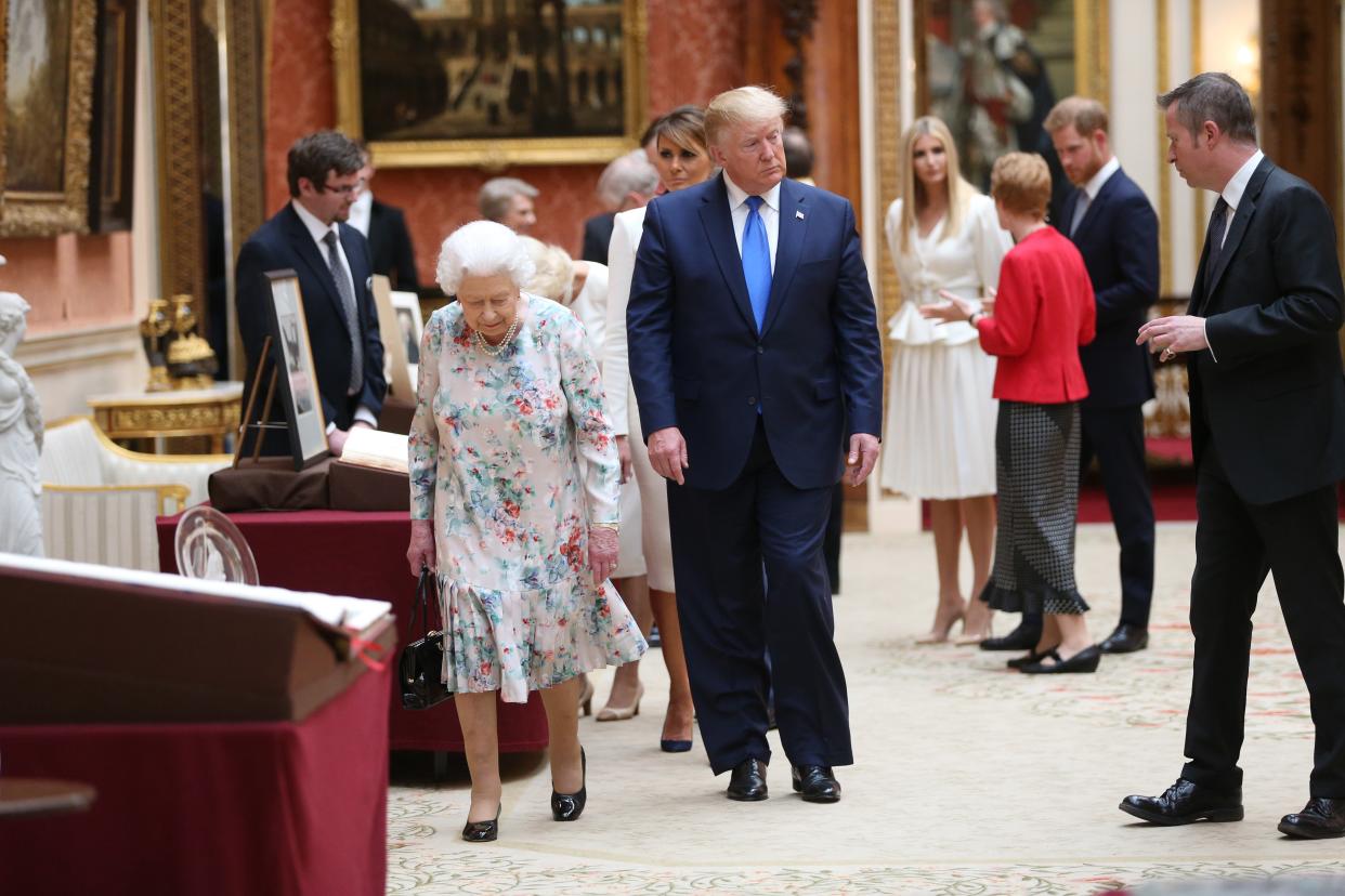 <p> Queen Elizabeth II (L) and US President Donald Trump (2nd L) view American items in the Royal collection while Ivanka Trump (4th R) daughter of US President Donald Trump, speaks with Prince Harry, Duke of Sussex (2nd R) at Buckingham Palace on June 3, 2019 in London, England.</p> (Photo by Ian Vogler - WPA Pool/Getty Images)