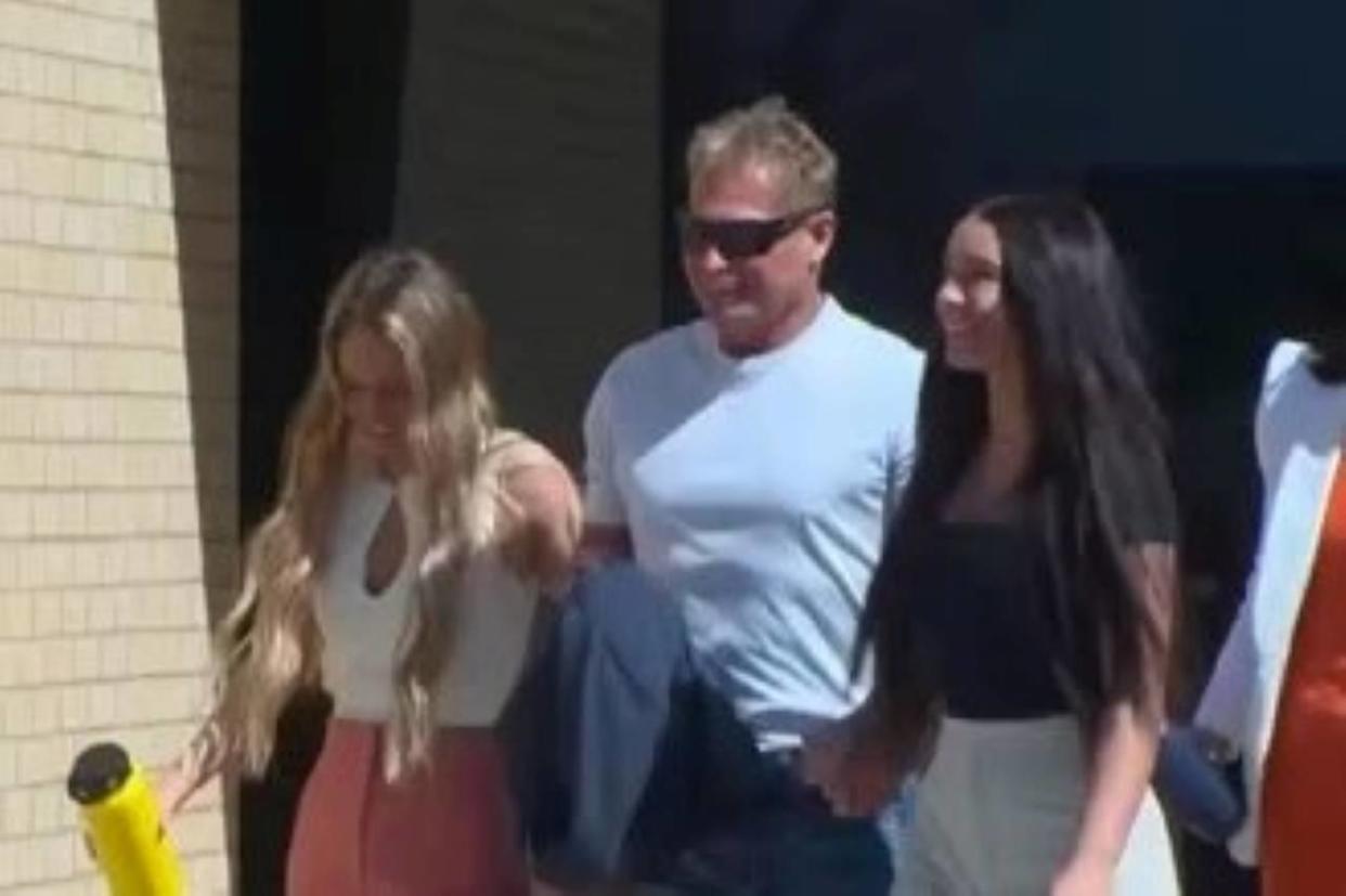 Barry Morphew, alongside his daughters, walks out of the Fremont County Courthouse in Colorado a free man after all charges against him are dismissed on April 19, 2022 / Credit: KKTV
