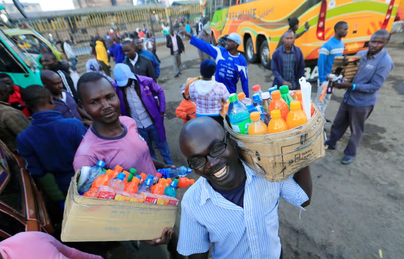 Hawkers sell soft drinks to passengers as residents leave for the villages amid concerns over the spread of coronavirus disease (COVID-19) in Nairobi