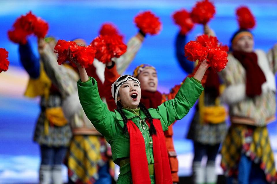 Actors cheer as President of the People's Republic of China, Xi Jinping, arrives for the opening ceremony of the 2022 Winter Olympics, Friday, Feb. 4, 2022, in Beijing. (AP Photo/David J. Phillip)