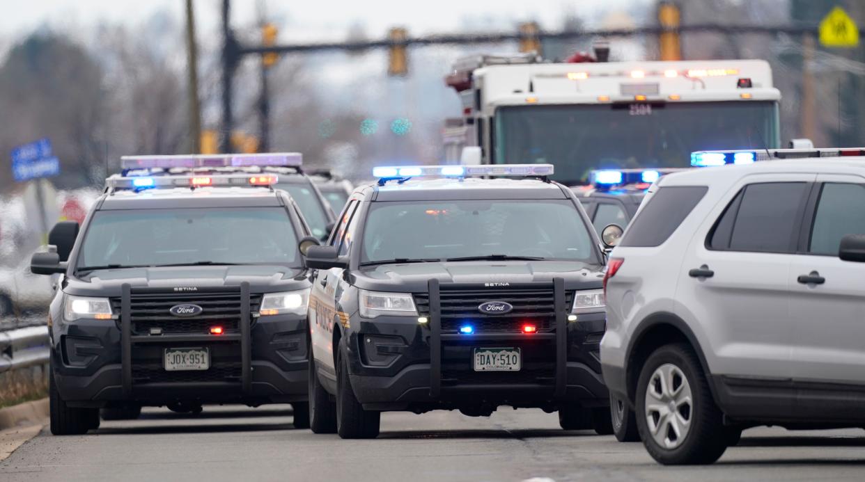 Police cars are parked outside a King Soopers grocery store where a shooting took place Monday, March 22, 2021, in Boulder, Colo.