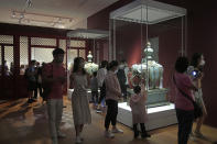 Visitors tour the Hong Kong Palace Museum during the first day open to public in Hong Kong, Sunday, July 3, 2022. The museum showcases more than 900 Chinese artefacts, loaned from the long-established Palace Museum in Beijing, home to works of art representing thousands of years of Chinese history and culture.(AP Photo/Kin Cheung)