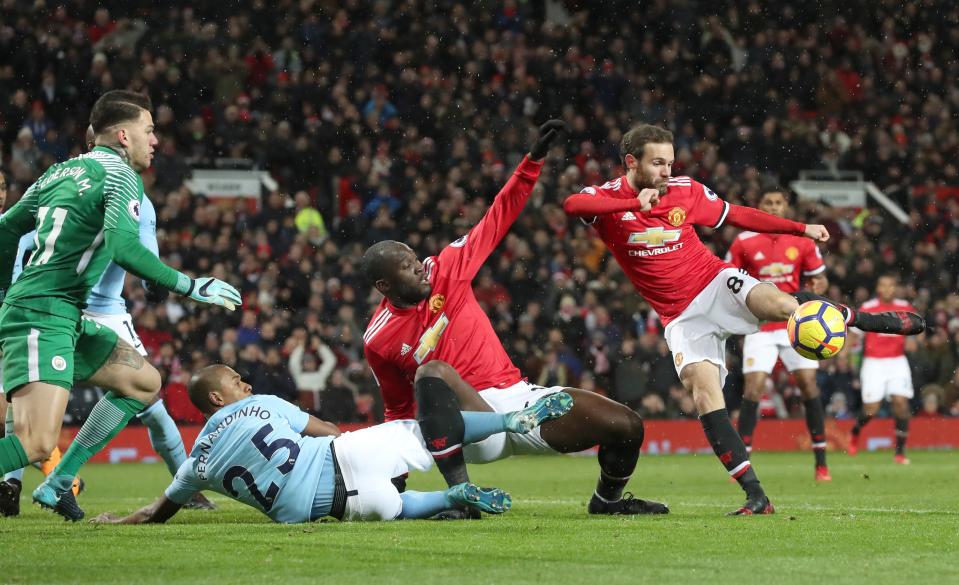 Juan Mata fires in a shot against Manchester City