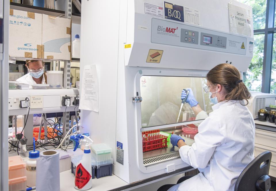 Photo shows a woman conducting scientific research in a lab. Source: AP