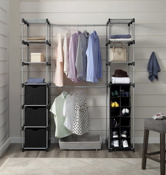 The closet system set up with clothes and accessories on it