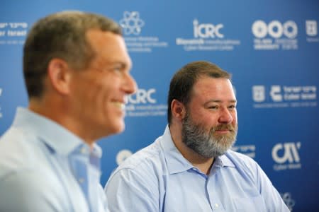 Derek Vadala, the chief executive of a joint venture between Moody's Corp and Israeli cyber group Team8, and Nadav Zafrir, CEO of Team8, smiles during an interview with Reuters at a cyber conference at Tel Aviv University