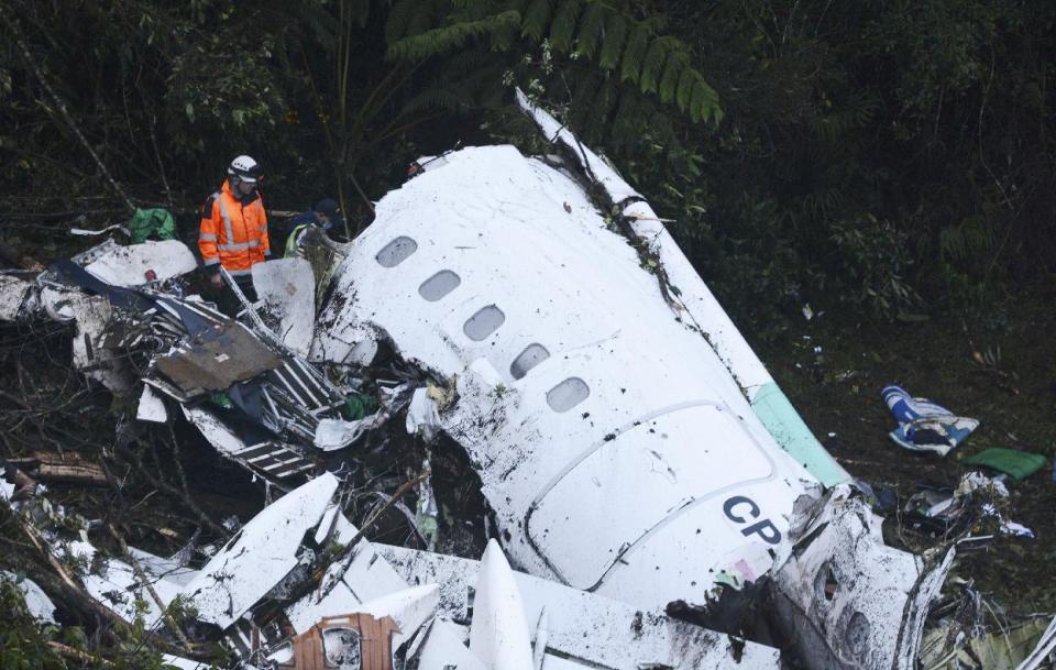 FILE - In this Nov. 29, 2016, file photo, rescue workers search at the wreckage site of a chartered airplane that crashed outside Medellin, Colombia. Three players survived and 19 players perished in the air crash almost two months ago in Colombia. (AP Photo/Luis Benavides, File)