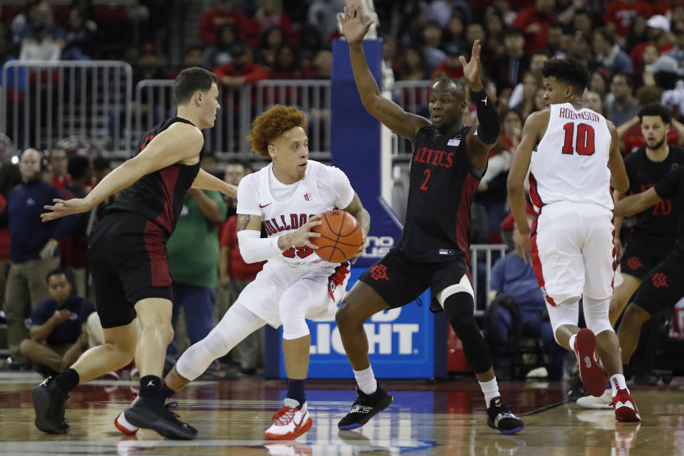 Fresno State's Noah Blackwell looks to drive on San Diego State's Adam Seiko, center right, during the first half of an NCAA college basketball game in Fresno, Calif., Tuesday Jan. 14, 2020. (AP Photo/Gary Kazanjian)