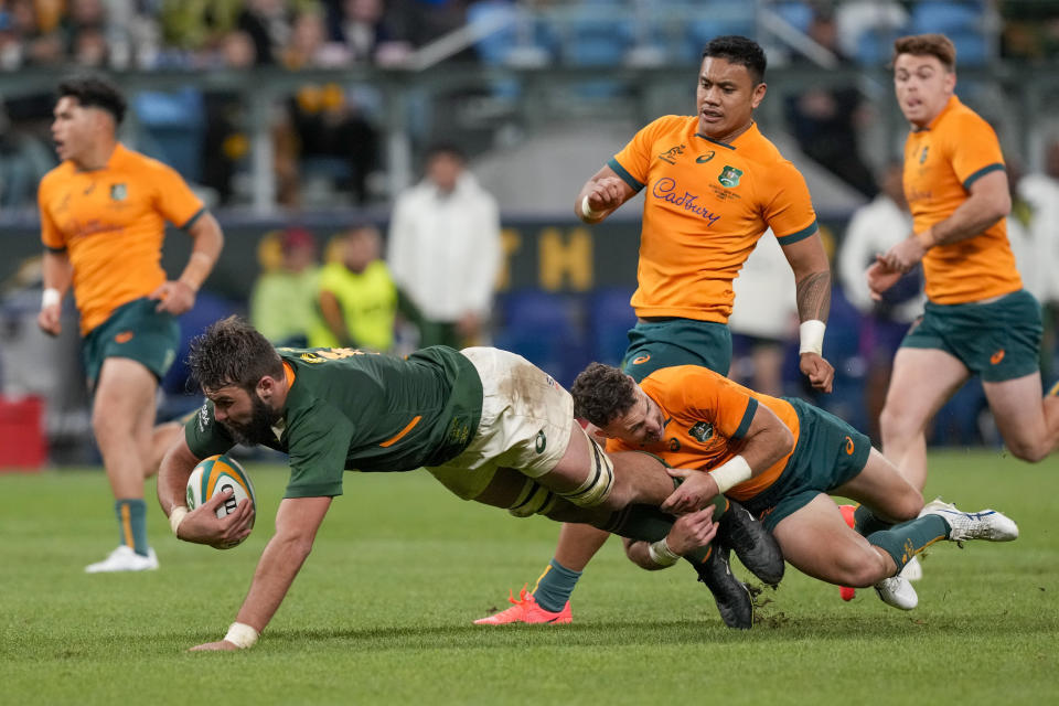 South Africa's Lood de Jager is tackled by Australia's Nic White during the second Rugby Championship test match between the Wallabies and the Springboks in Sydney, Australia, Saturday, Sept. 3, 2022. (AP Photo/Mark Baker)