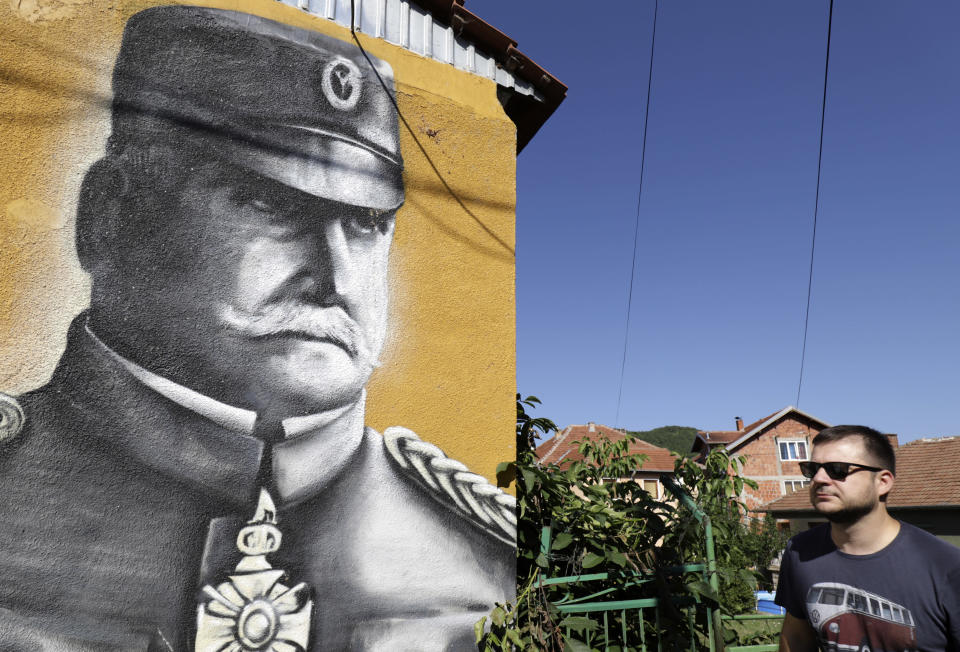 A man passes by a mural depicting Radomir Putnik, Serbian Minister of War and Field Marshal in both Balkan Wars of 1912-13, from which Serbia emerged with her territorial mass doubled in size, in the town of Zvecan, Kosovo, Tuesday, Aug. 16, 2022. Wartime rivals Serbia and Kosovo are to hold high level crisis talks which the European Union mediators hope will de-escalate growing tensions in the Balkans, where Russia has been trying to further increase its influence amid the war in Ukraine. (AP Photo/Bojan Slavkovic)