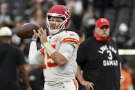 Kansas City Chiefs head coach Andy Reid, right, wears a shirt paying tribute to Buffalo Bills safety Damar Hamlin as he watches Chiefs quarterback Patrick Mahomes warm up before the start of an NFL football game between the Las Vegas Raiders and Kansas City Chiefs Saturday, Jan. 7, 2023, in Las Vegas. (AP Photo/David Becker)