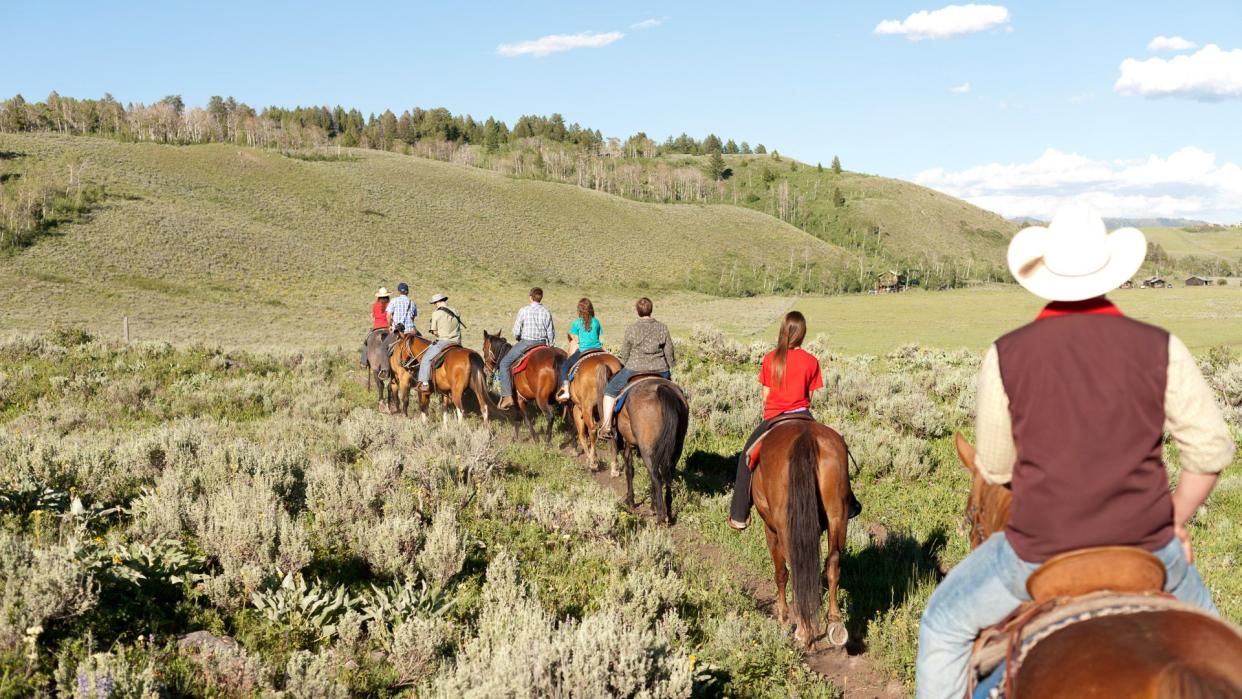 Guests take a horseback ride, Parade Rest Ranch, Grayling Creek, West Yellowstone, Montana, USA.