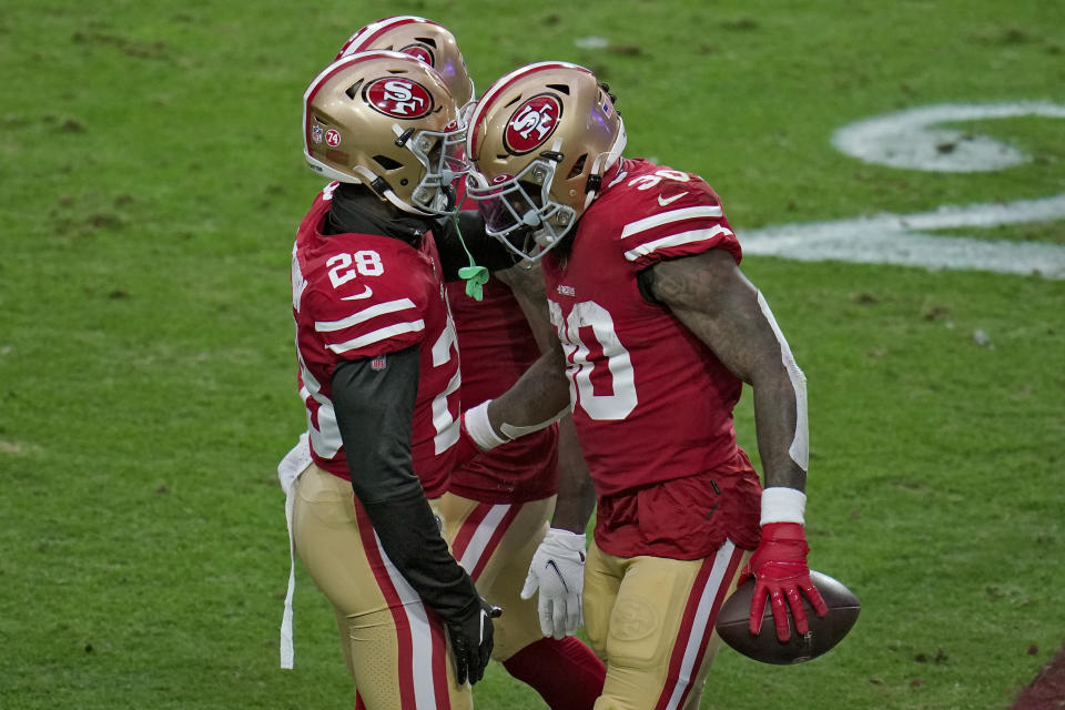 San Francisco 49ers running back Jeff Wilson (30) celebrates his touchdown with running back Jerick McKinnon (28) during the first half of an NFL football game against the Washington Football Team, Sunday, Dec. 13, 2020, in Glendale, Ariz. (AP Photo/Ross D. Franklin)