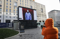 A giant screen streams a Prada fashion live show during the Milan's fashion week in Milan, Italy, Sunday, Jan. 17, 2021. (AP Photo/Luca Bruno)